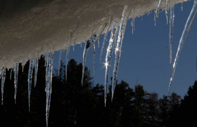 Icicles hang from a roof top.