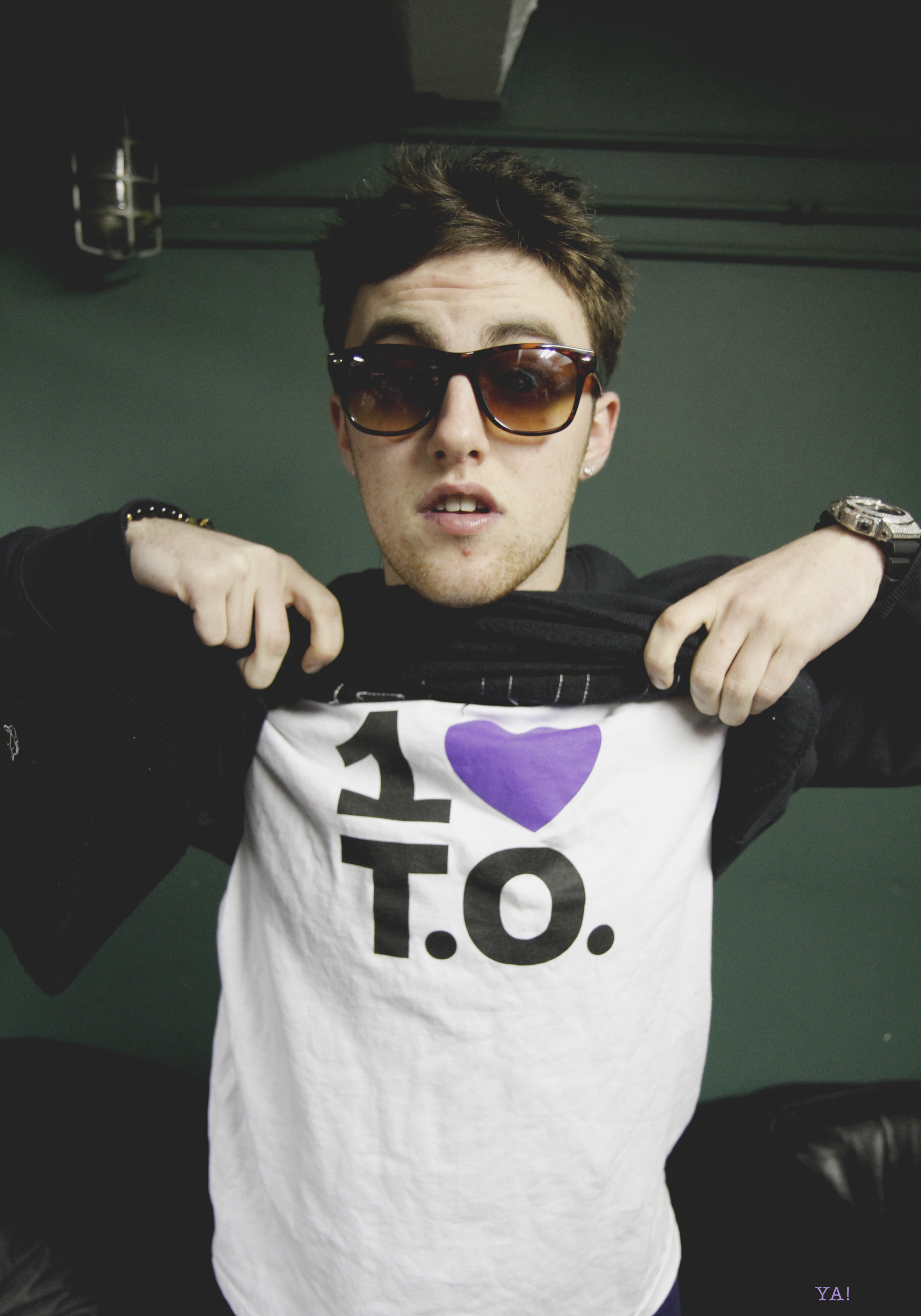 Mac Miller wearing a One Love T.O. shirt