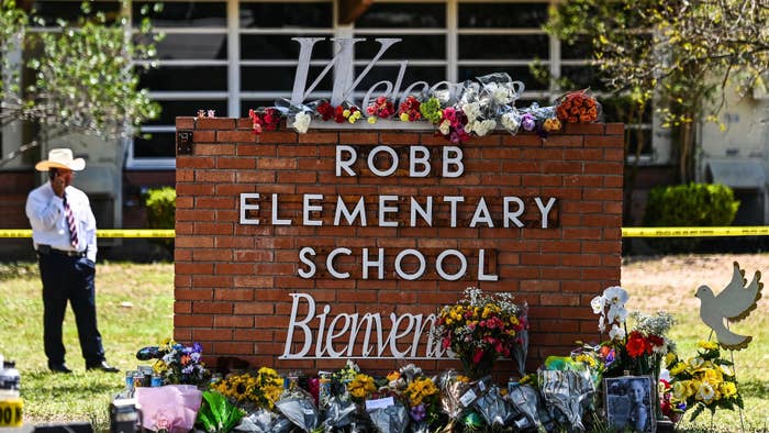 Flowers are placed on a makeshift memorial in front of Robb Elementary School in Uvalde