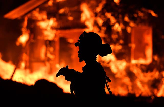 An inmate firefighter monitors flames