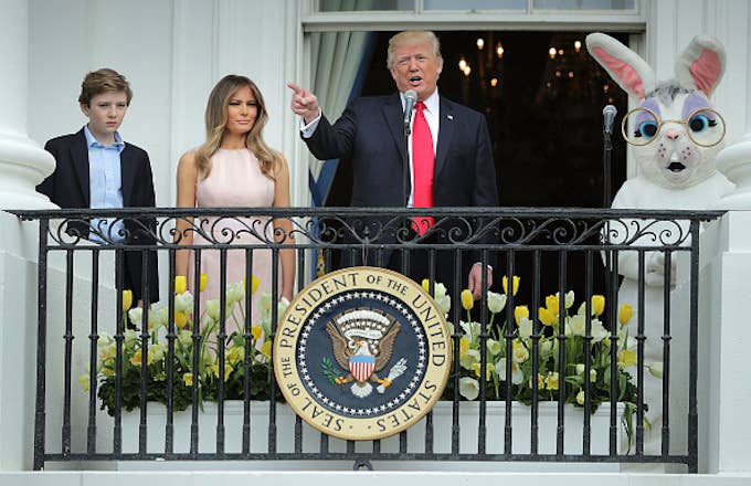 Donald Trump (C) delivers remarks from the Truman Balcony