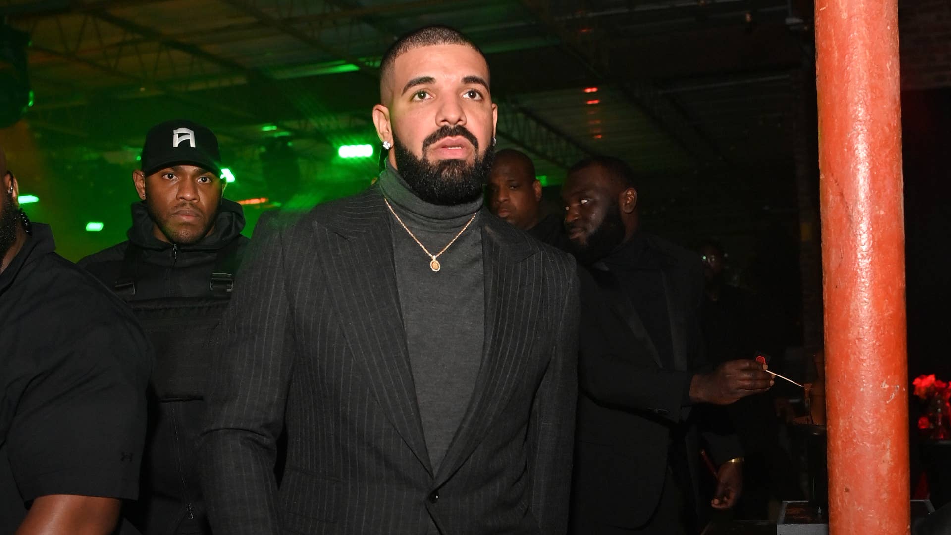 Drake wears a blazer at an event.