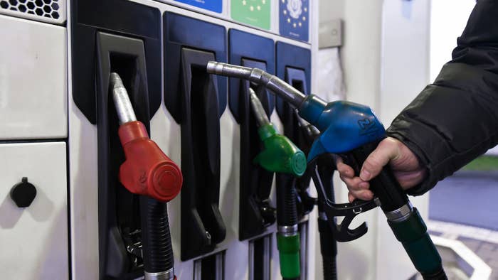 Man pumping gas at station