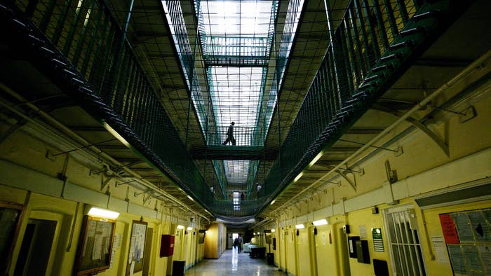Photograph of a person walking in a prison
