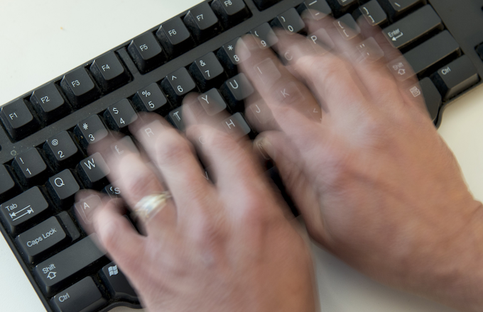 Person typing on a keyboard.