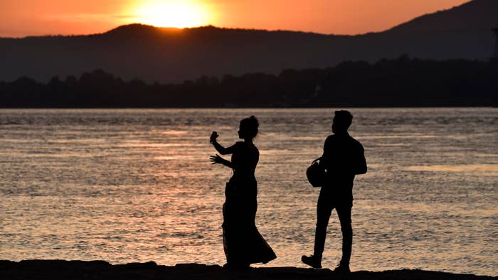 A couple takes selfie during sunset in banks of Brahmaputra river, in Guwahati, Assam, India.