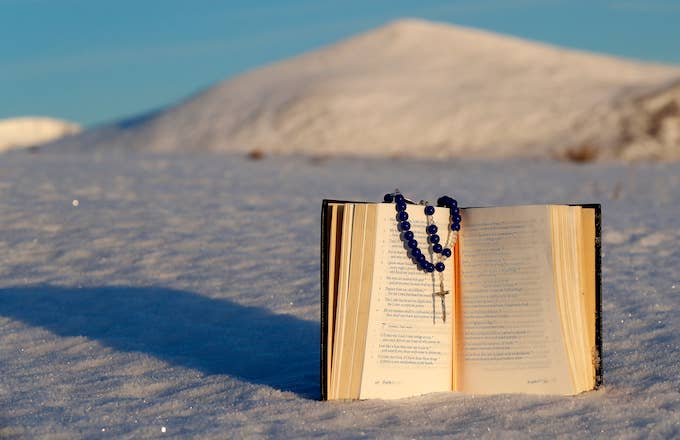 Book of common prayer and rosary on snow..
