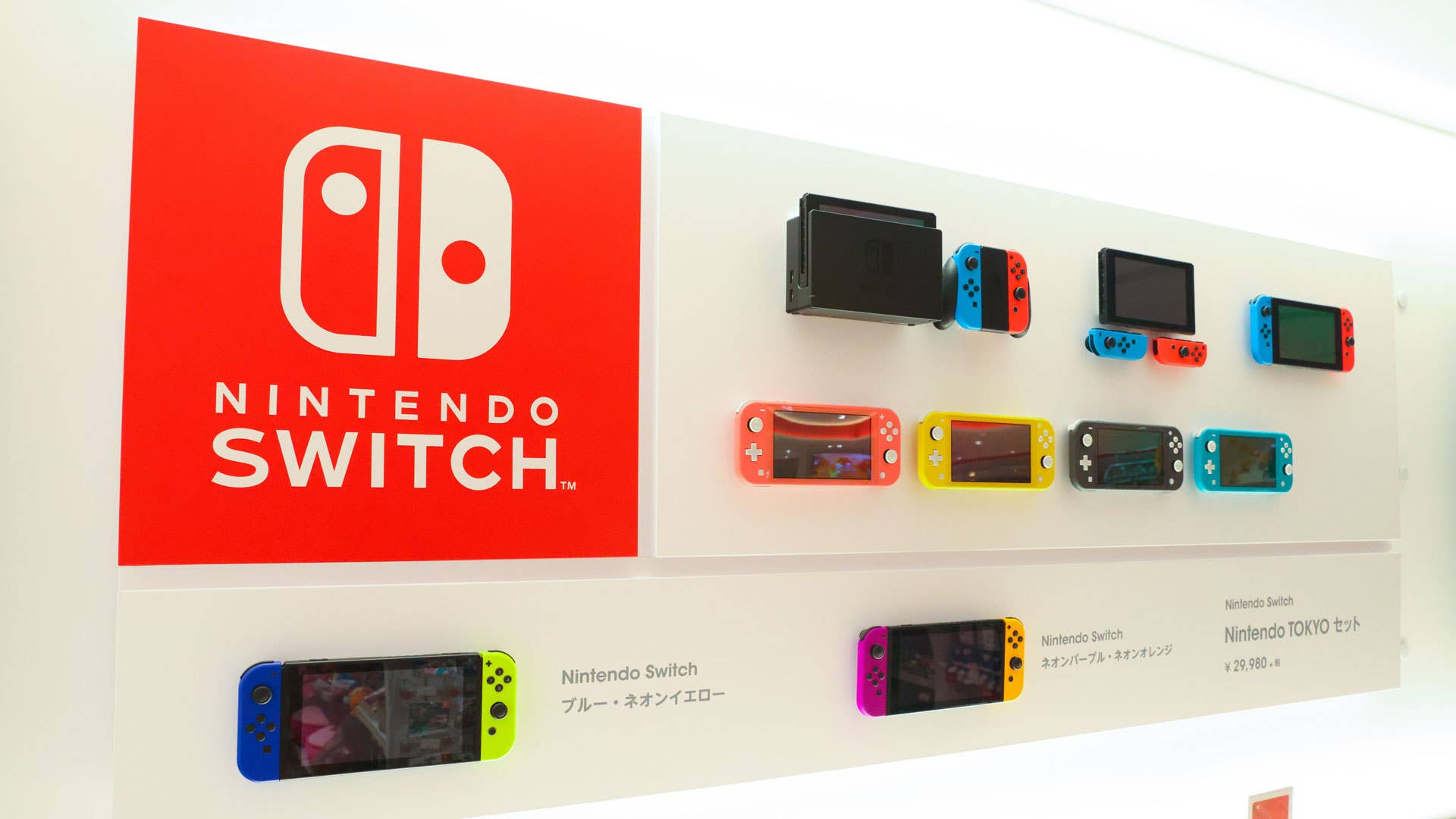 A wall of Nintendo Switches on display.
