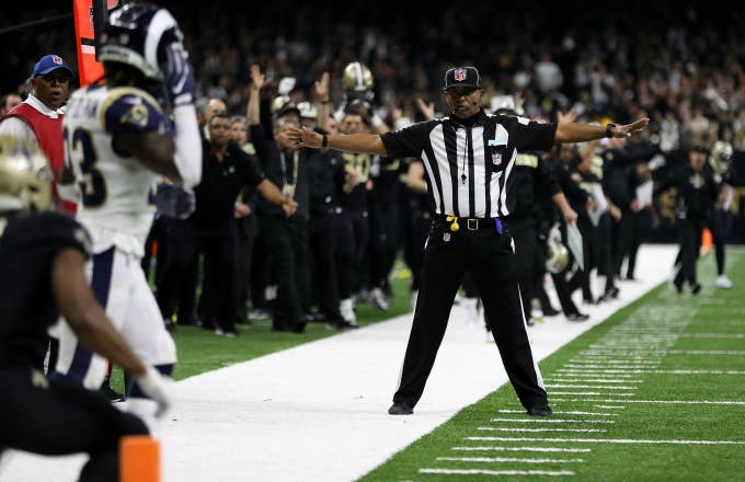 A referee watches as Tommylee Lewis #11 of the New Orleans Saints drops a pass