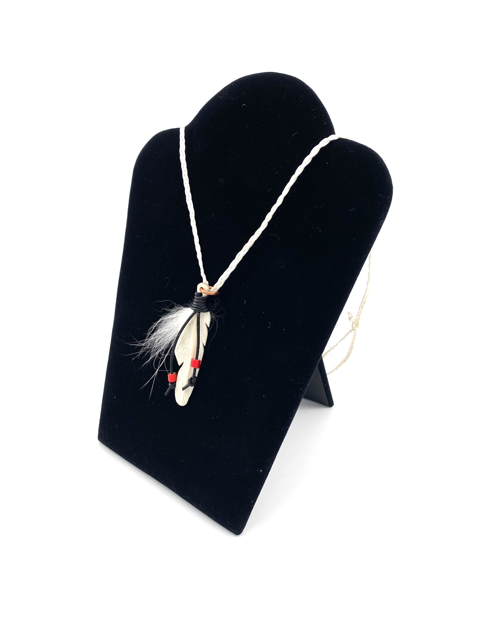 Caribou feather necklace on a black bust