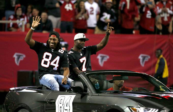 Ex Falcons Michael Vick and Roddy White wave to the crowd at the Georgia Dome.