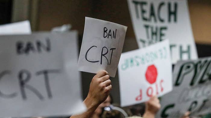 Signs are held at a Placentia Yorba Linda School Board meeting