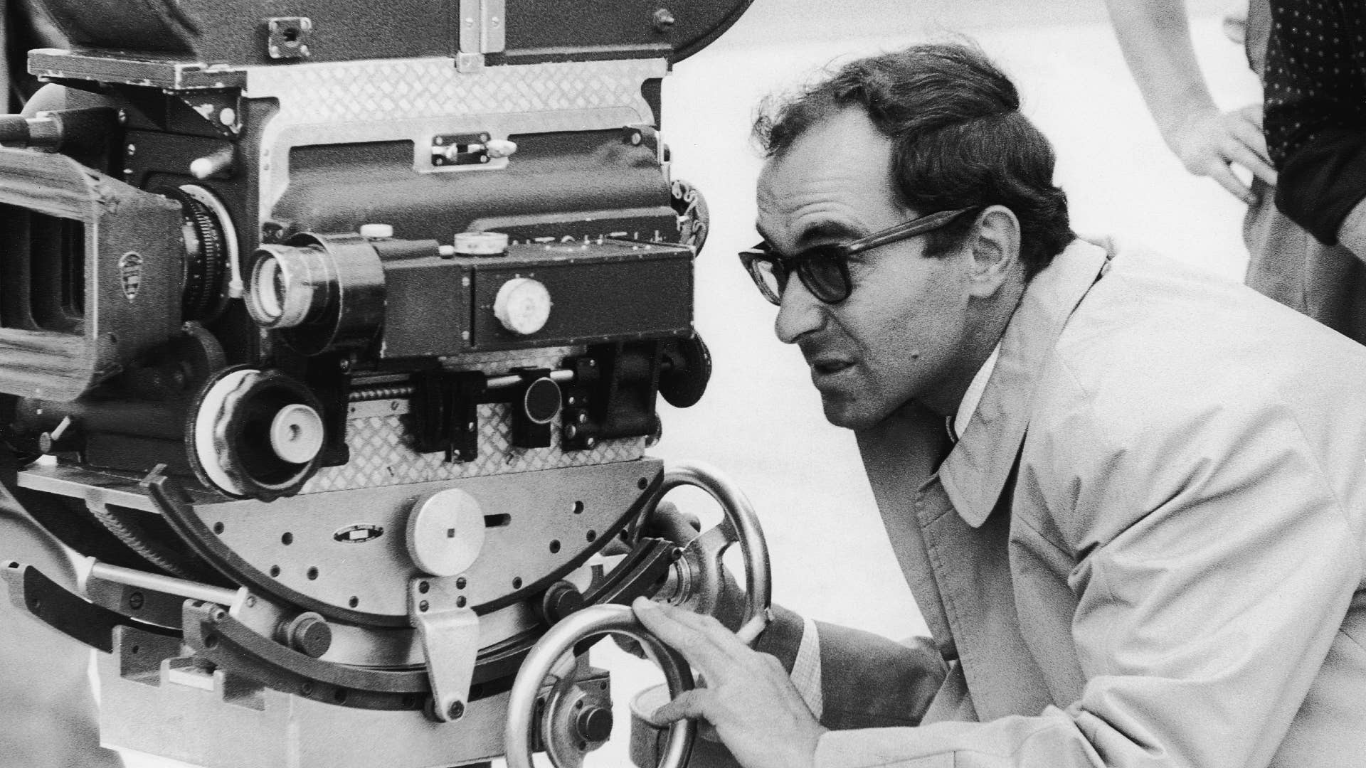 Director Jean Luc Godard is seen behind the camera