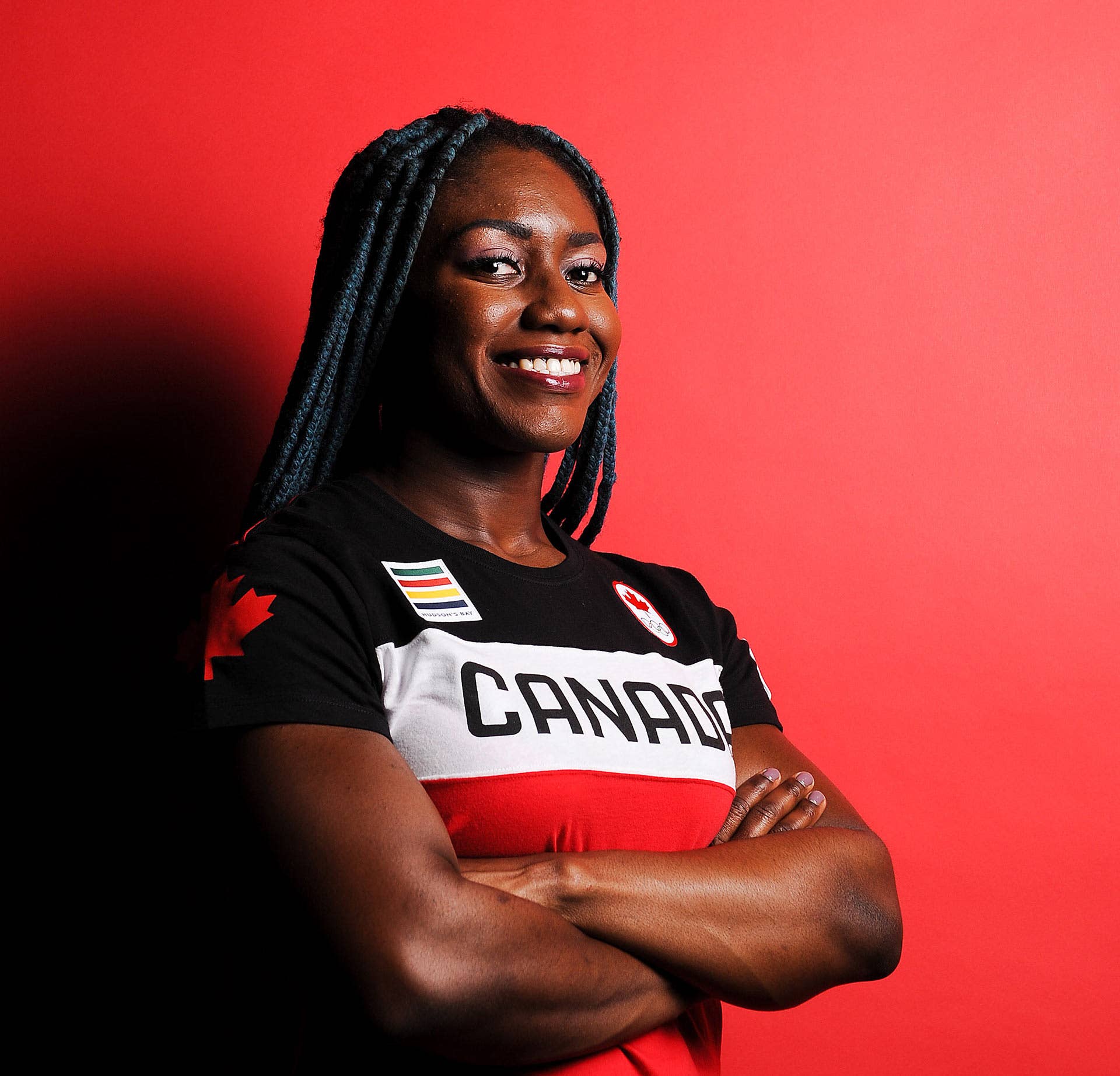 Canadina bobsledder Cynthia Appiah poses against red background
