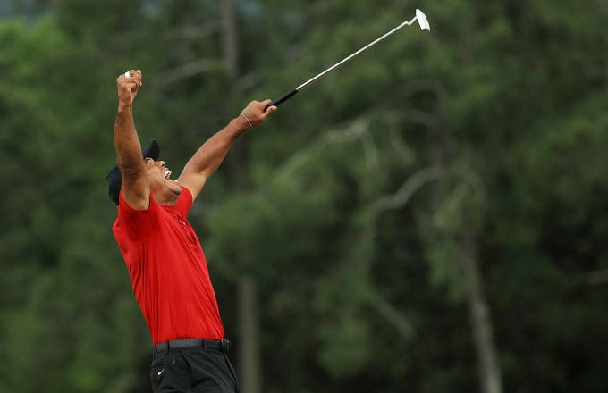 Tiger Woods of the United States celebrates after sinking his putt on the 18th green