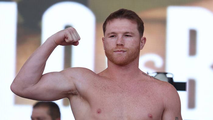 Canelo Alvarez poses on the scale during a ceremonial weigh-in at Toshiba Plaza