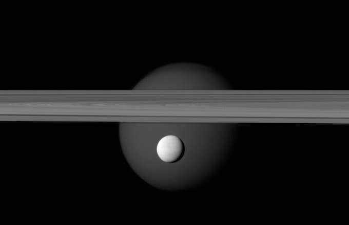 Enceladus appears before Saturn&#x27;s rings