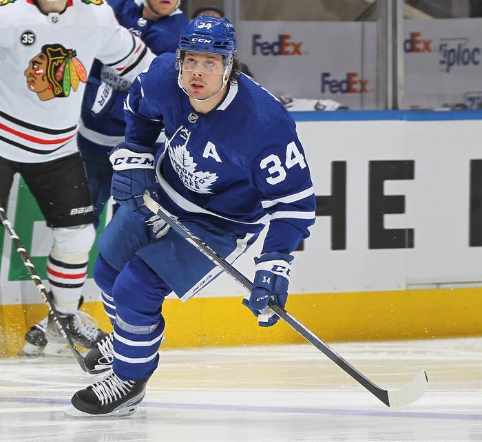 Auston Matthews #34 of the Toronto Maple Leafs eyes a high puck
