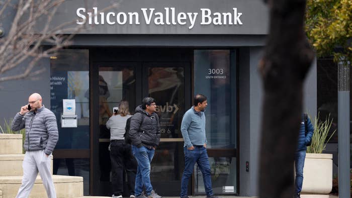 Employees stand outside of the shuttered Silicon Valley Bank