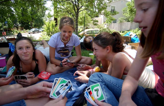 Girls play the card game UNO.
