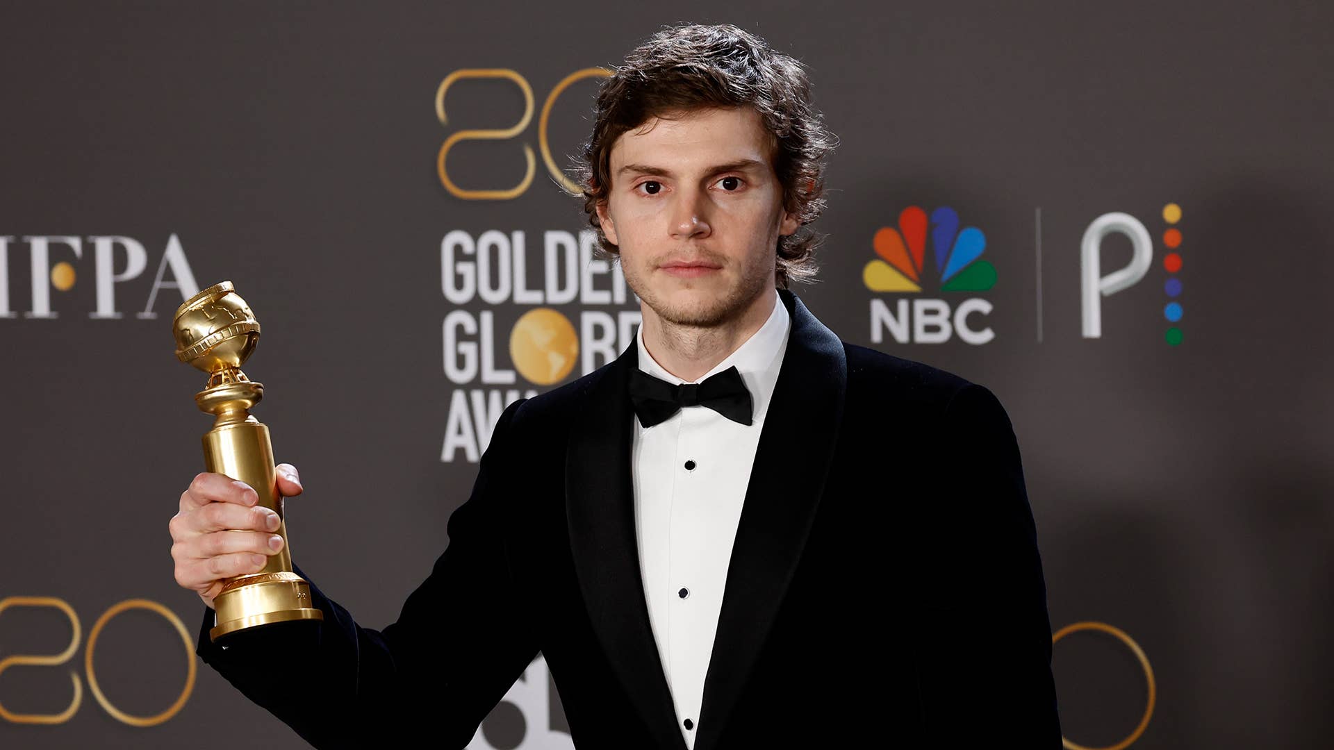 Evan Peters poses with the Best Actor in a Limited or Anthology Series or Television Film award
