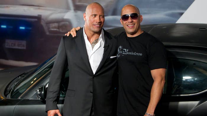 Dwayne Johnson (The Rock) and Vin Diesel (R) pose for photographers.