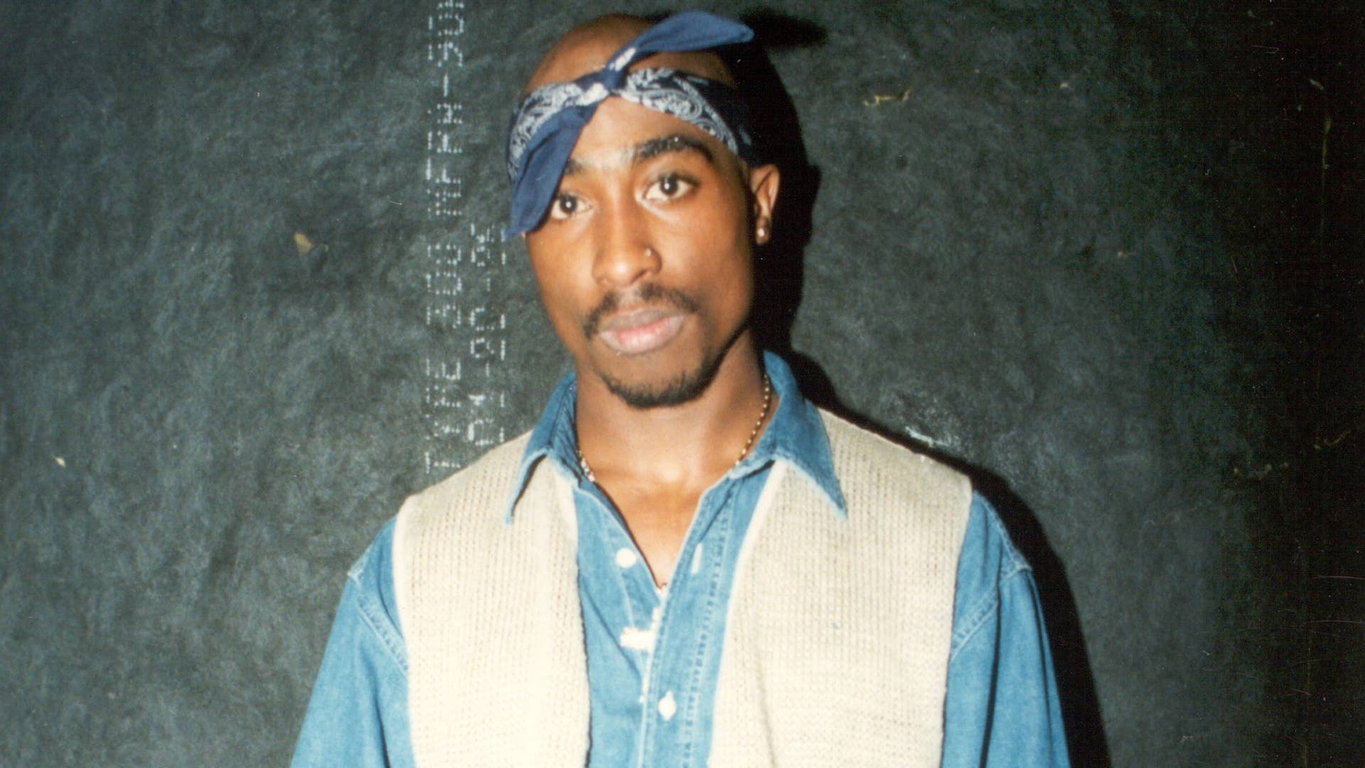 2Pac poses backstage after a show