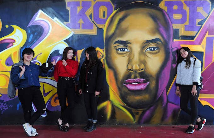 Kobe Bryant mural with young adults