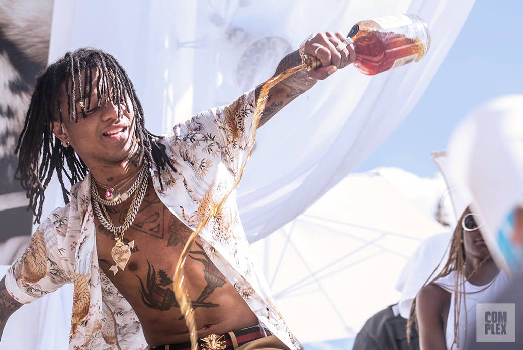 Swae Lee of Rae Sremmurd pouring out a bottle of Hennessy during his SremmLife Sundays performance.