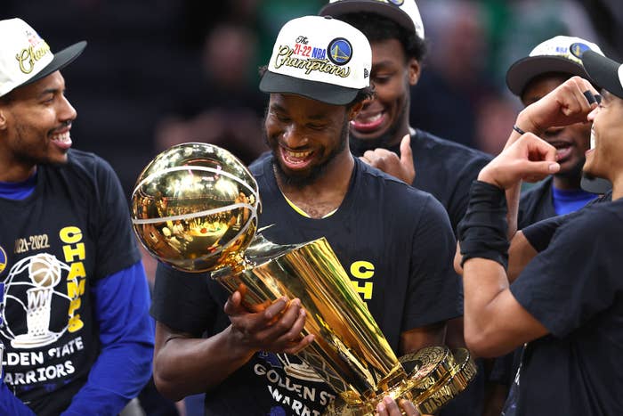 Andrew Wiggins holds the Larry O&#x27;Brien trophy