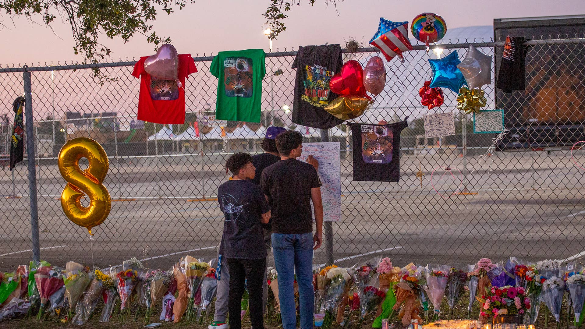 People pay their respects at the site of the Astroworld 2021 crowd crush.
