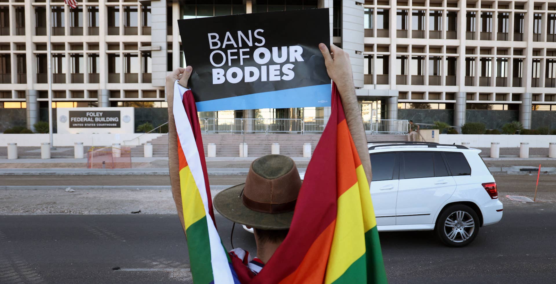 A man protests LGBTQ rights outside of a courthouse