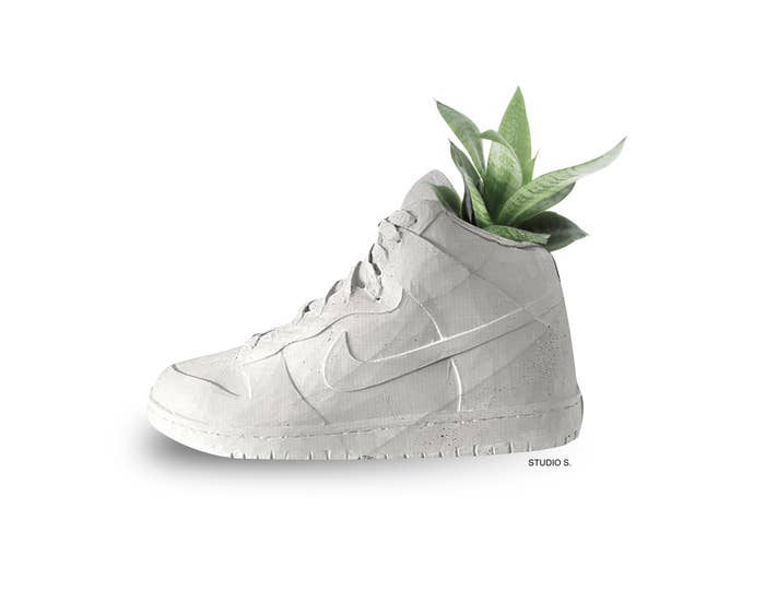 White sneaker planter with green plant
