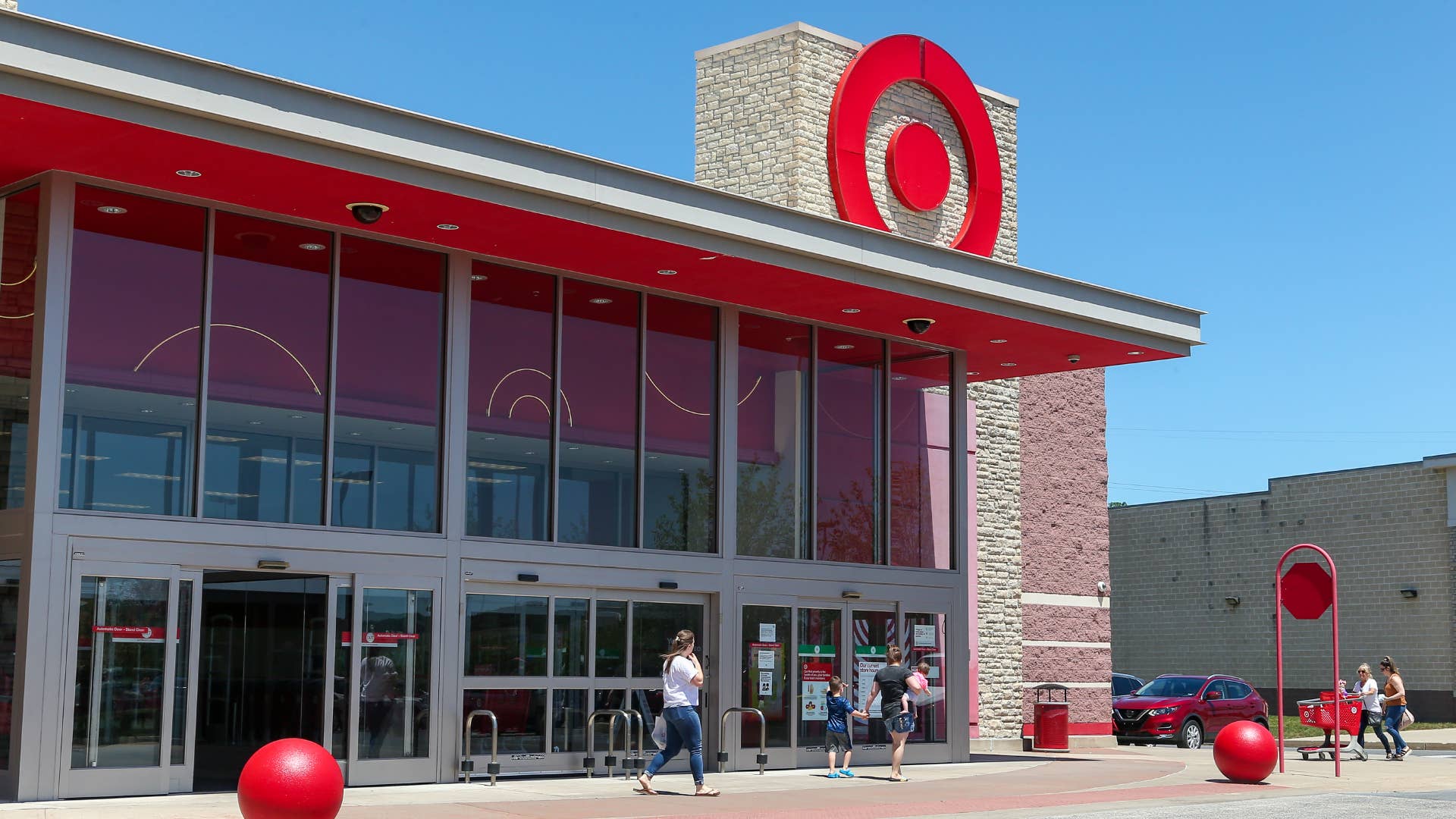 Shoppers are seen walking near a Target store.