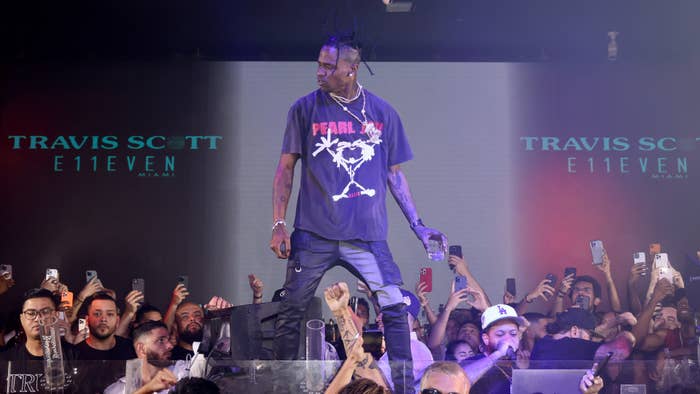 Travis Scott is pictured performing at a club