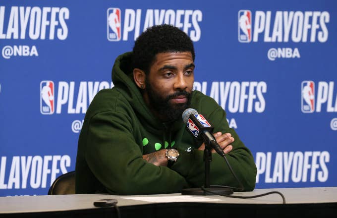 Kyrie Irving #11 of the Boston Celtics speaks to the media