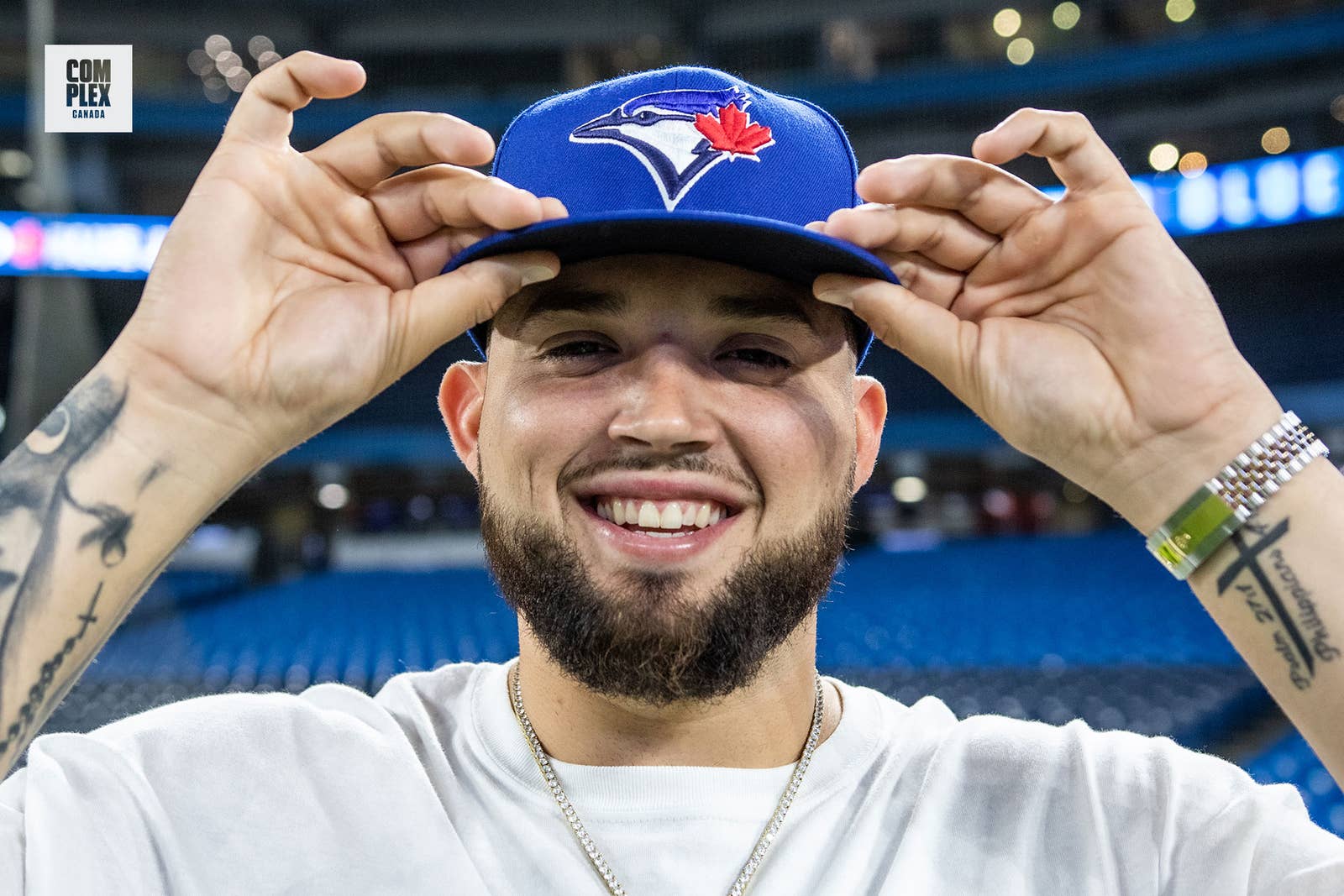 Toronto Blue Jays pitcher Alek Manoah poses with jays hat