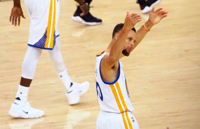 Steph Curry motions to crowd.
