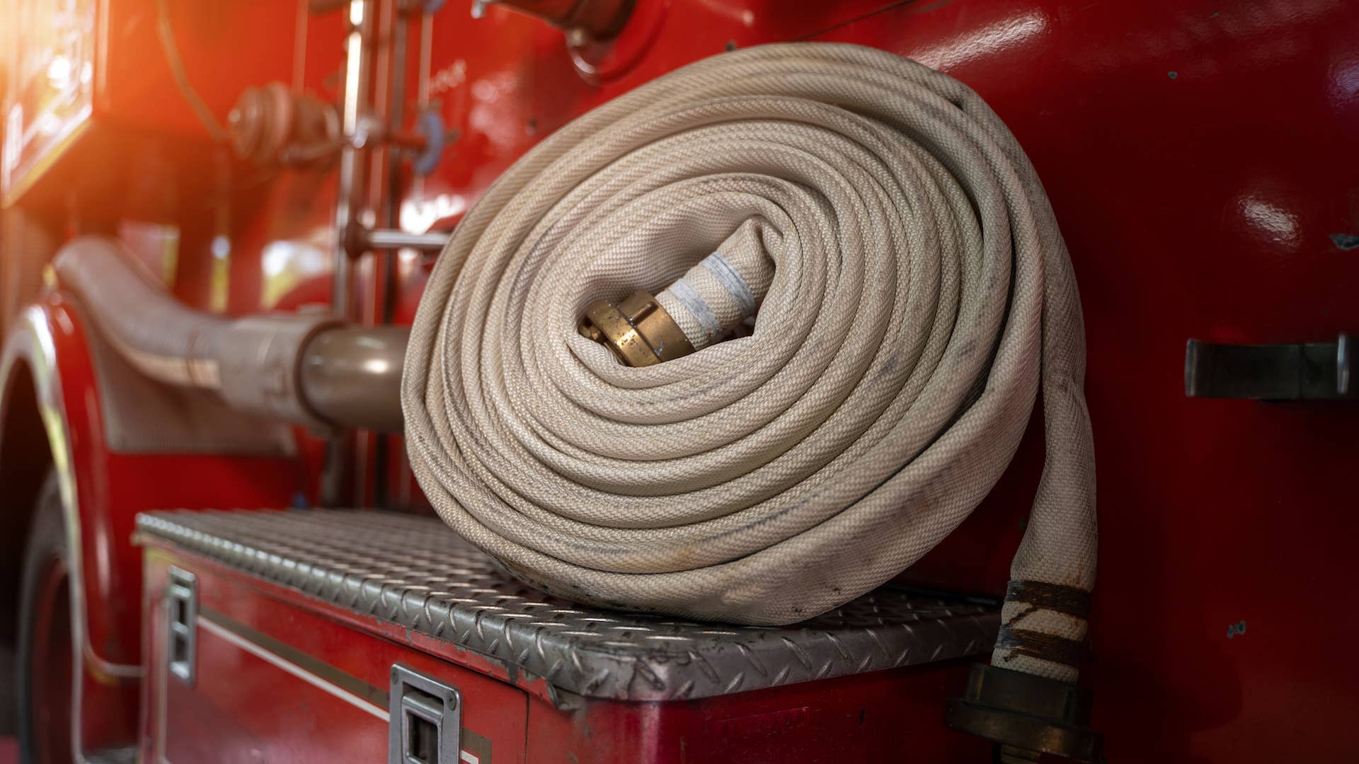 This is a picture of a Fire hose on fire truck and Firemen equipment.