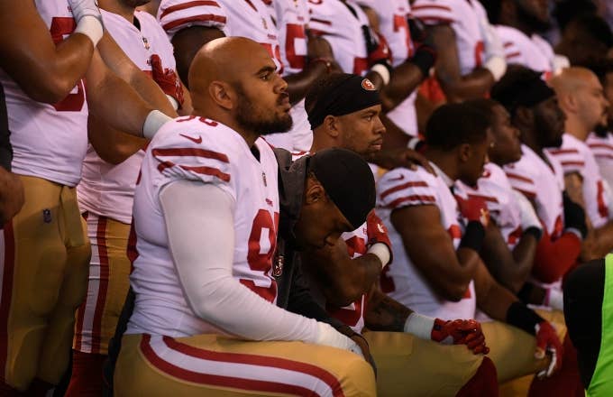 49ers players take a knee.