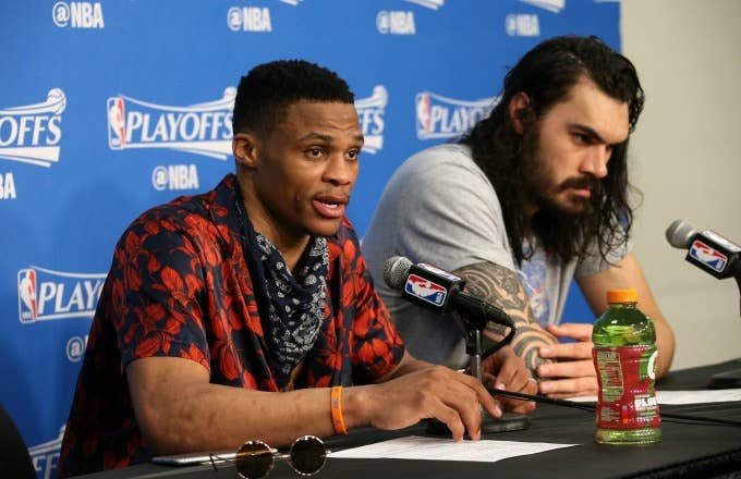 Russell Westbrook speaks at a press conference alongside Steven Adams.