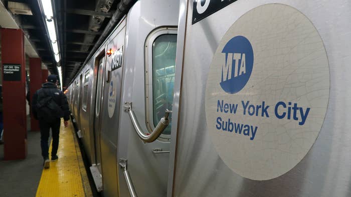 A subway train pulls into a station under Rockefeller Center.