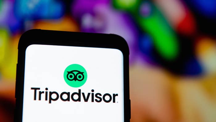 In this photo illustration a Tripadvisor logo seen displayed on a smartphone