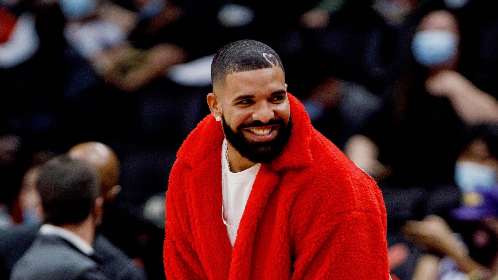 : Drake attends a preseason NBA game between the Toronto Raptors and the Houston Rockets