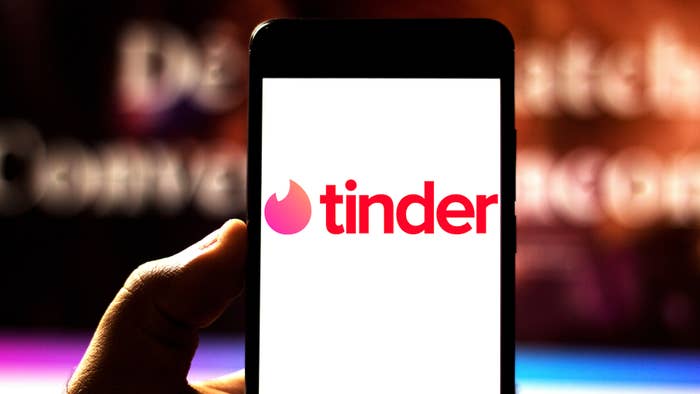 Photograph of person using Tinder app