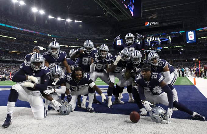 The Cowboys celebrate in the end zone after a score.