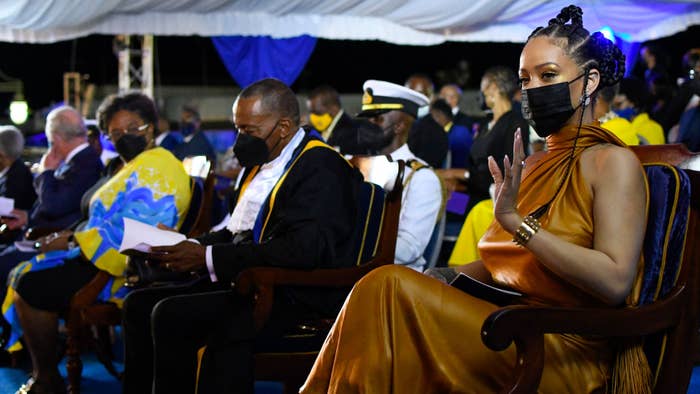 Rihanna waves at the crowd during a special ceremony.