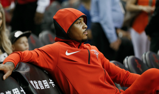 Carmelo Anthony #7 of the Houston Rockets looks on from the bench