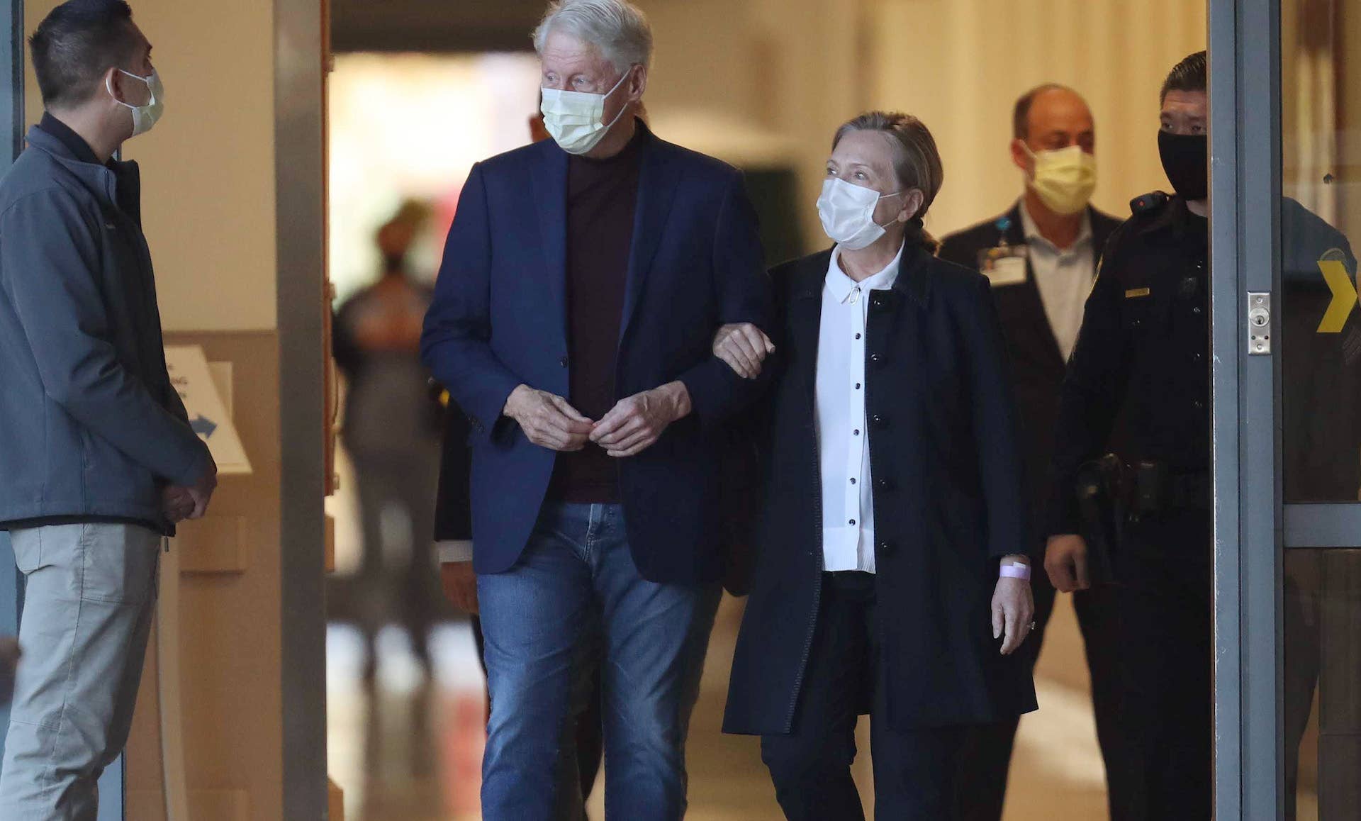Bill Clinton and his wife Hilary, exiting hospital
