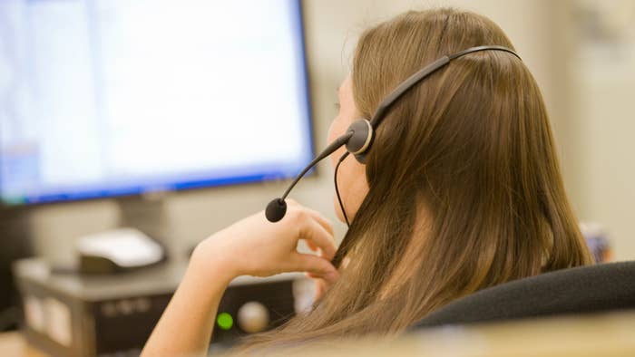 A woman is seen working at a call center